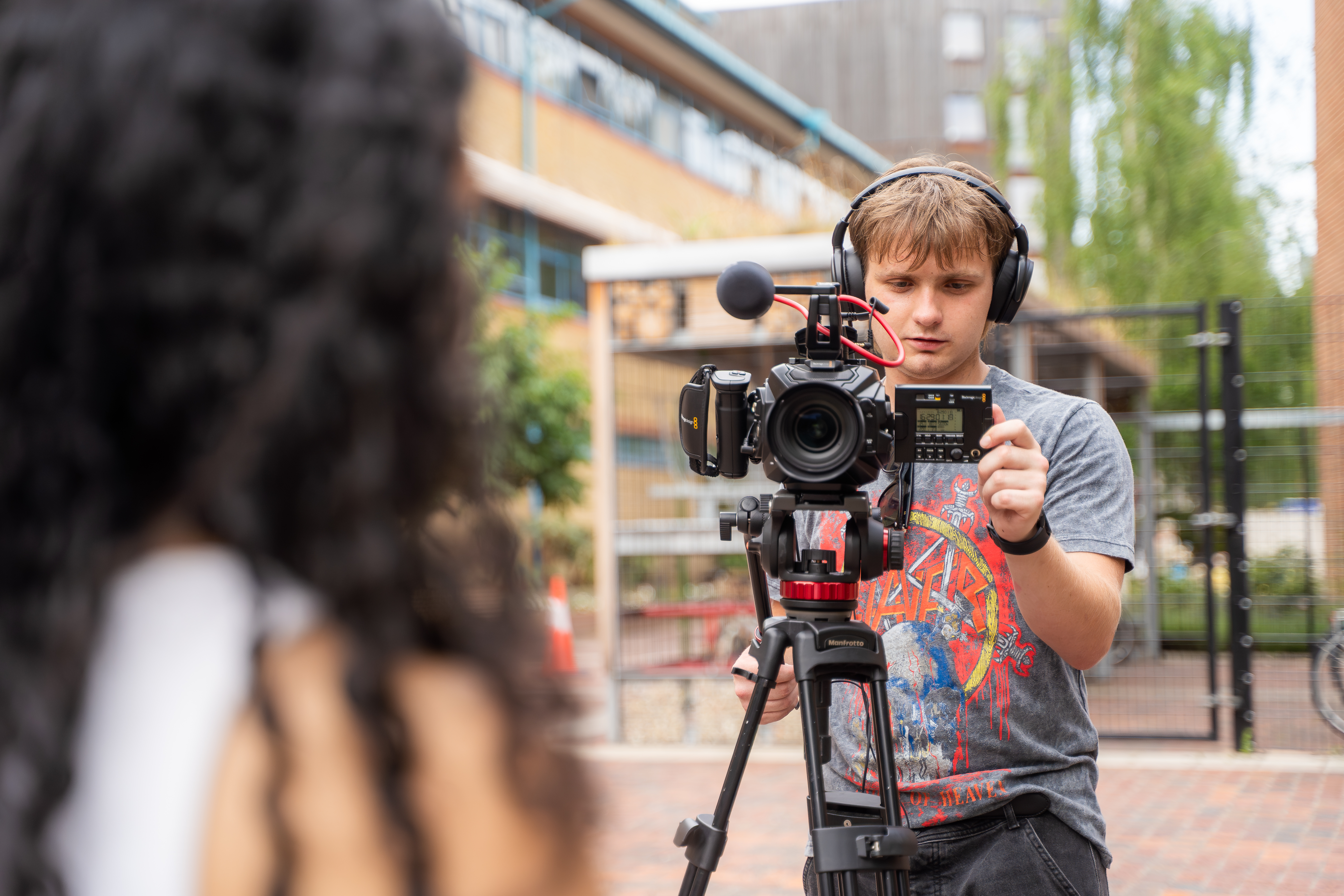 A film student using camera to film