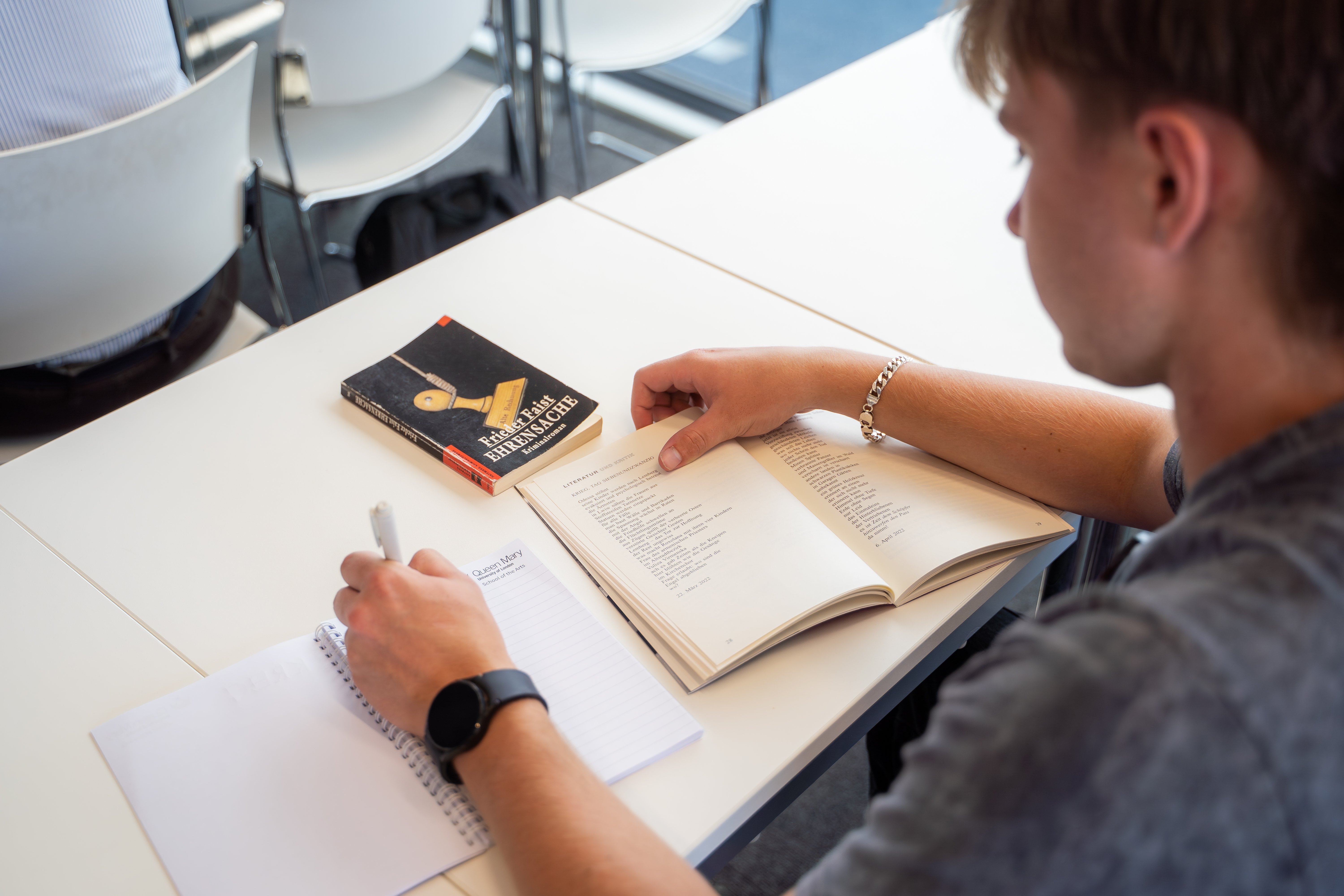 Student writing in lecture