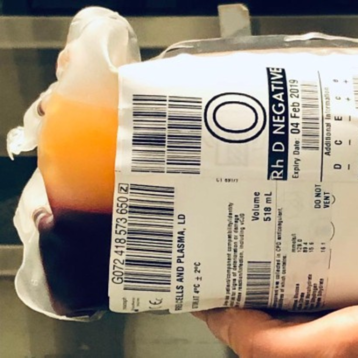 A person holding a bag of blood for transfusion