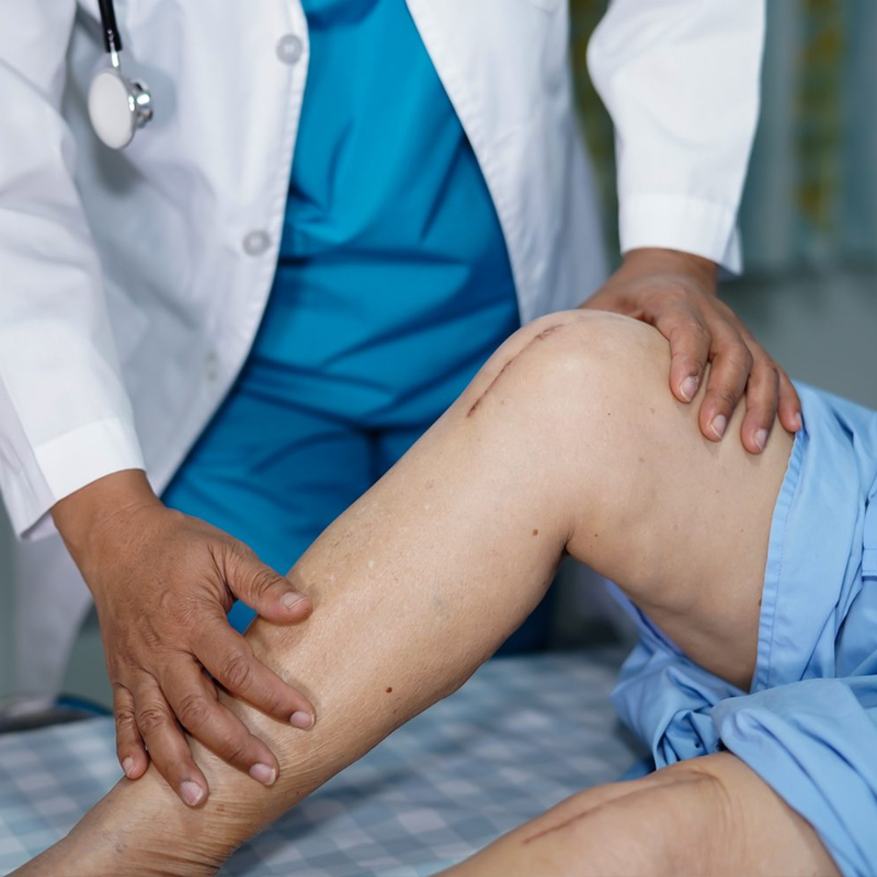 A doctor examining a patient's knee