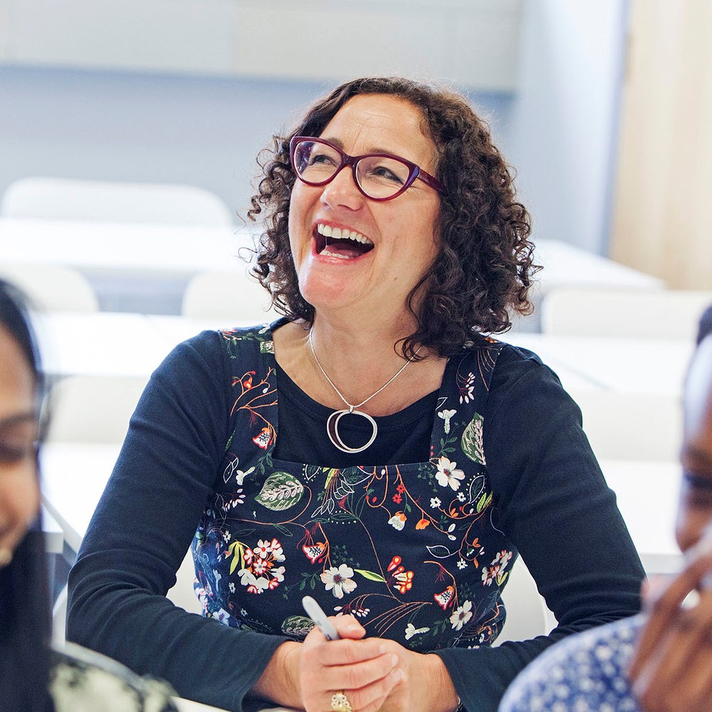 Woman laughing with other people