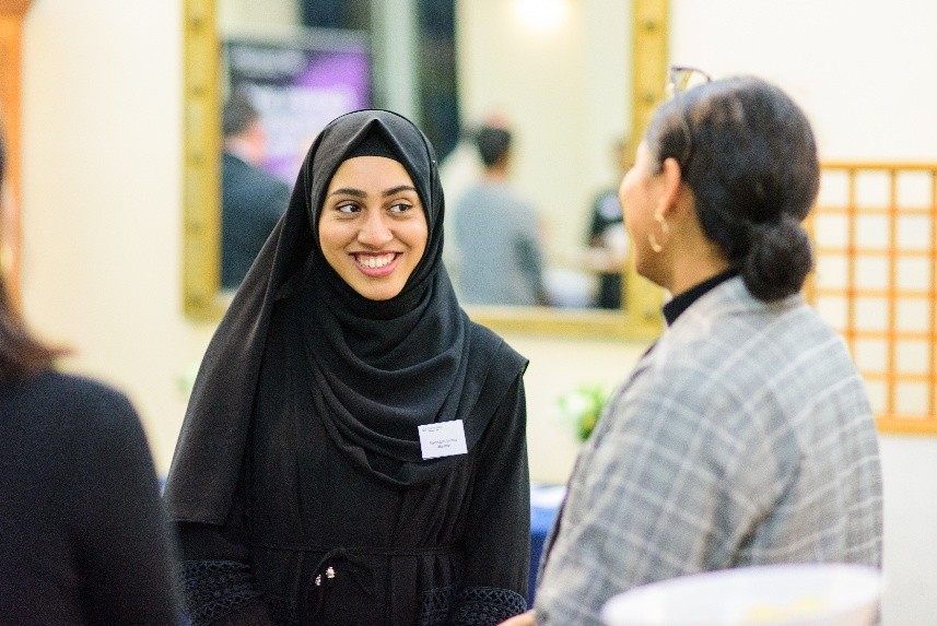 Two women talking and smiling