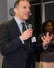 Ian Walden speaking into a microphone at an event.