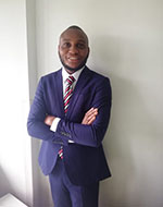 Nuel Oji wearing a blue suit