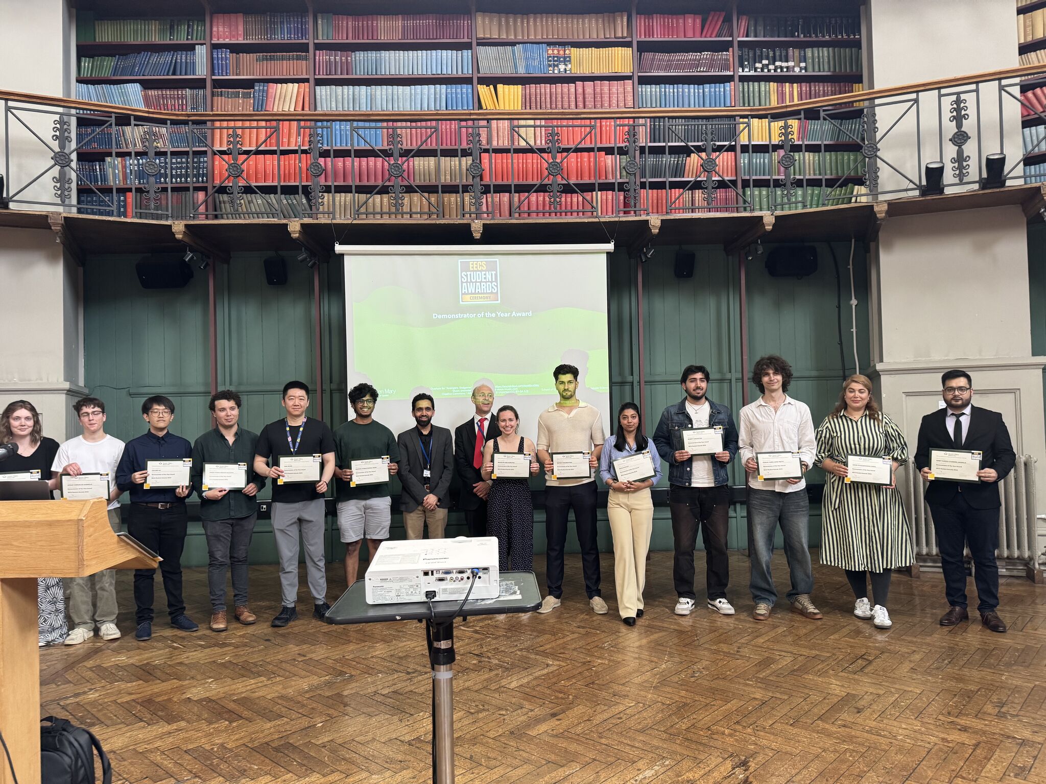 Group of students facing the camera and holding awards