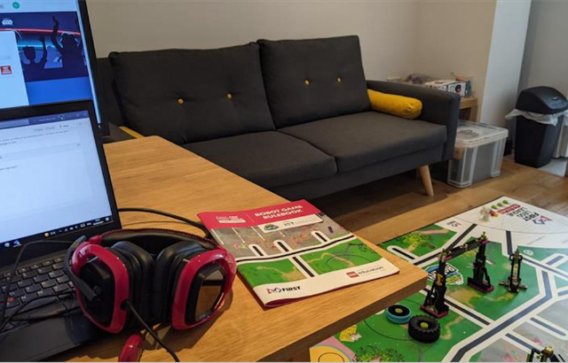 A laptop, pair of headphones and lego tournament