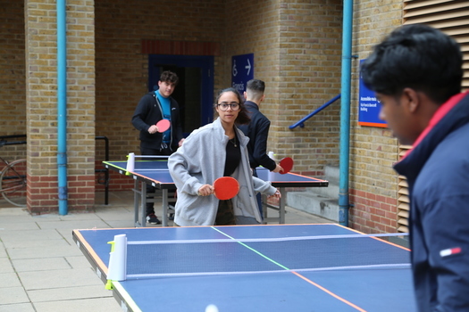 Female student playing ping pong