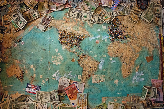 A map of the world with bank notes on it