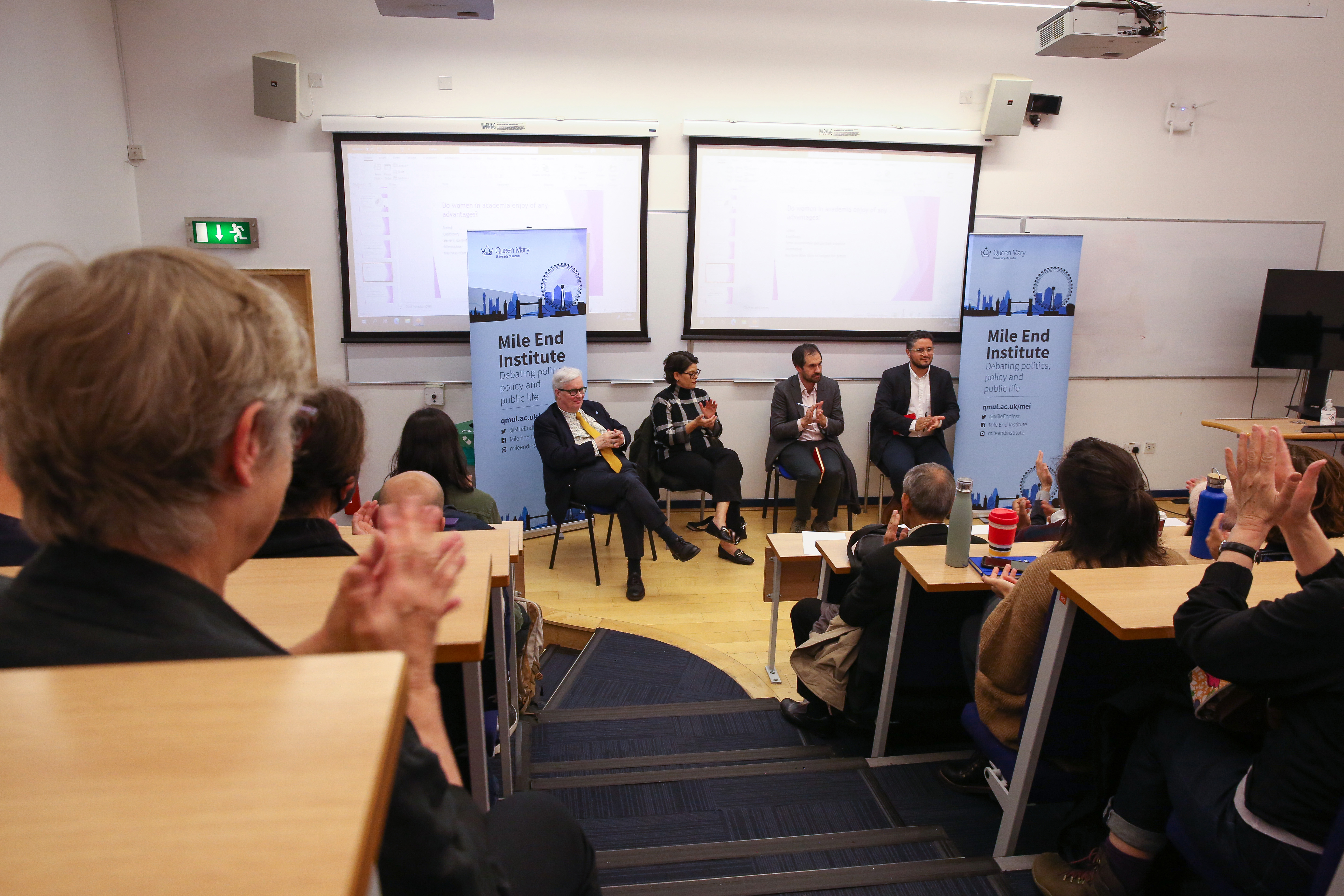 Panellists with audience clapping