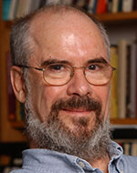 Duncan Kennedy. He is wearing a blue denim shirt and glasses.