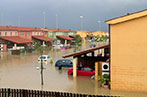 A flooded street of terracotta coloured houses in Sicily.
