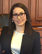 Maria Fanou wearing a black blazer and white top.