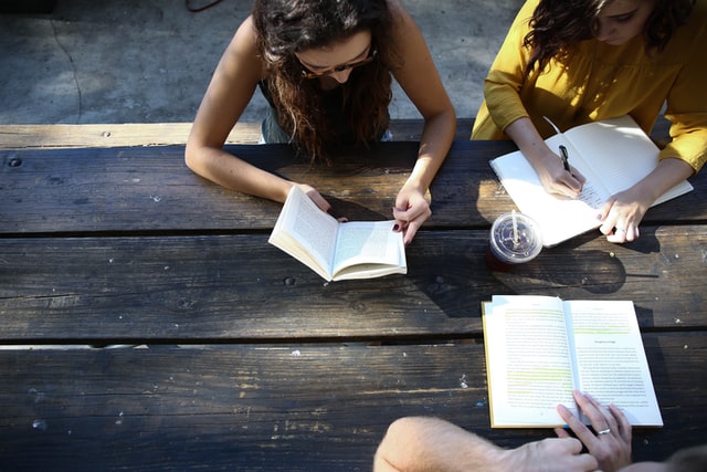 students reading books together