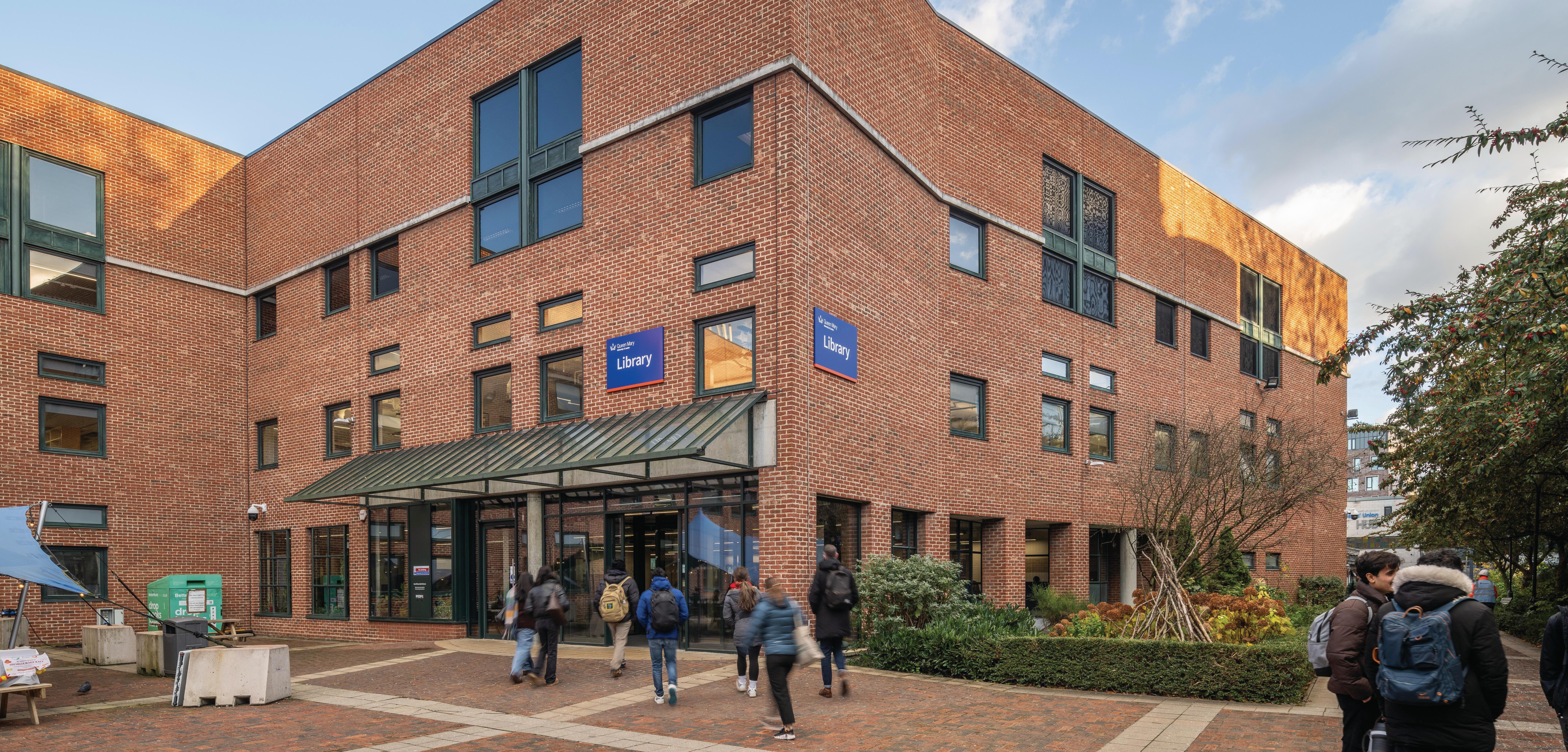 Students walking into Mile End library from library square