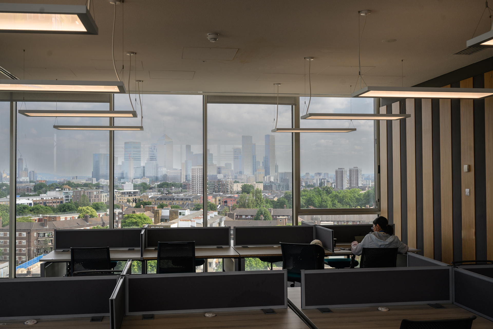 Study desks in reading room with one student studying