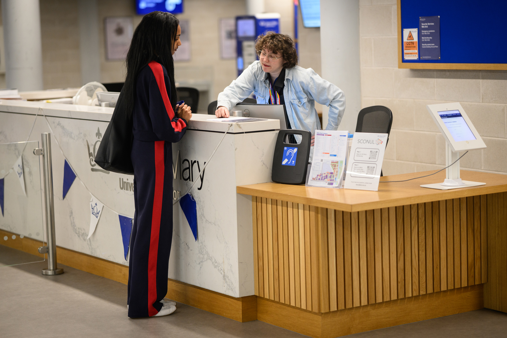 Student talking to library staff at Welcome Desk