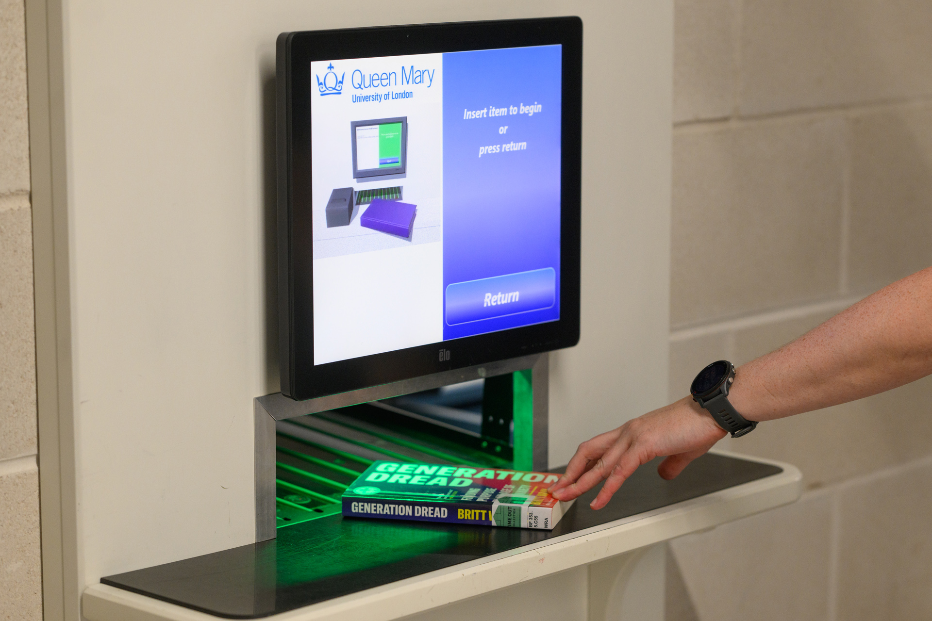 Placing a book in the book returns slot