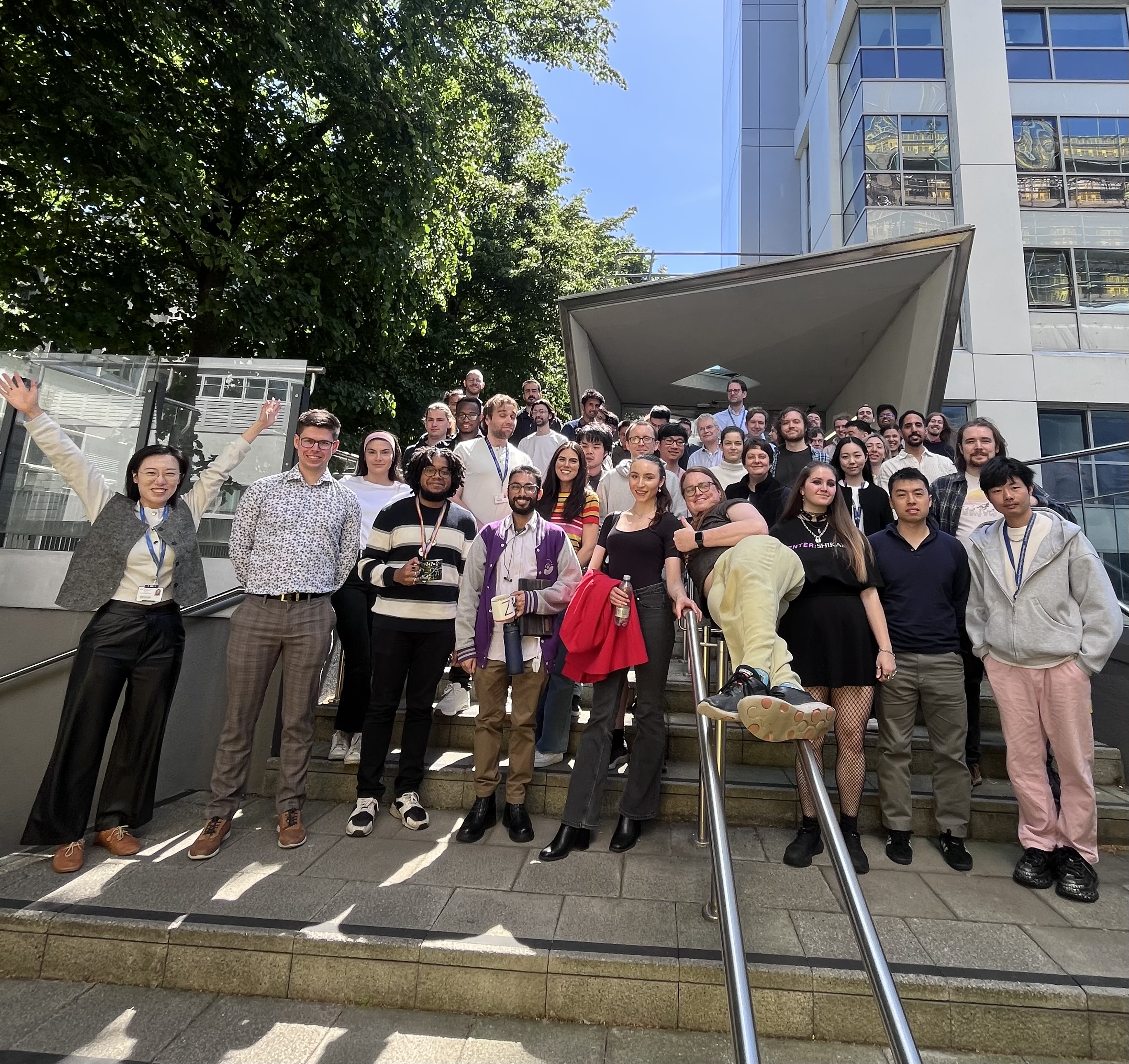 PhD students on the steps of the Maths building, May 2025