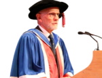Picture of David in blue graduation gown and black felt graduation hat