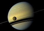 A giant of a moon appears before a giant of a planet undergoing seasonal changes in this natural color view of Titan and Saturn from NASA's Cassini spacecraft.Credit: NASA/JPL-Caltech/Space Science Institute.