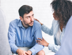 A woman reassures a man