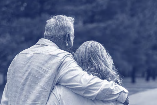 Two people with their arms around each other