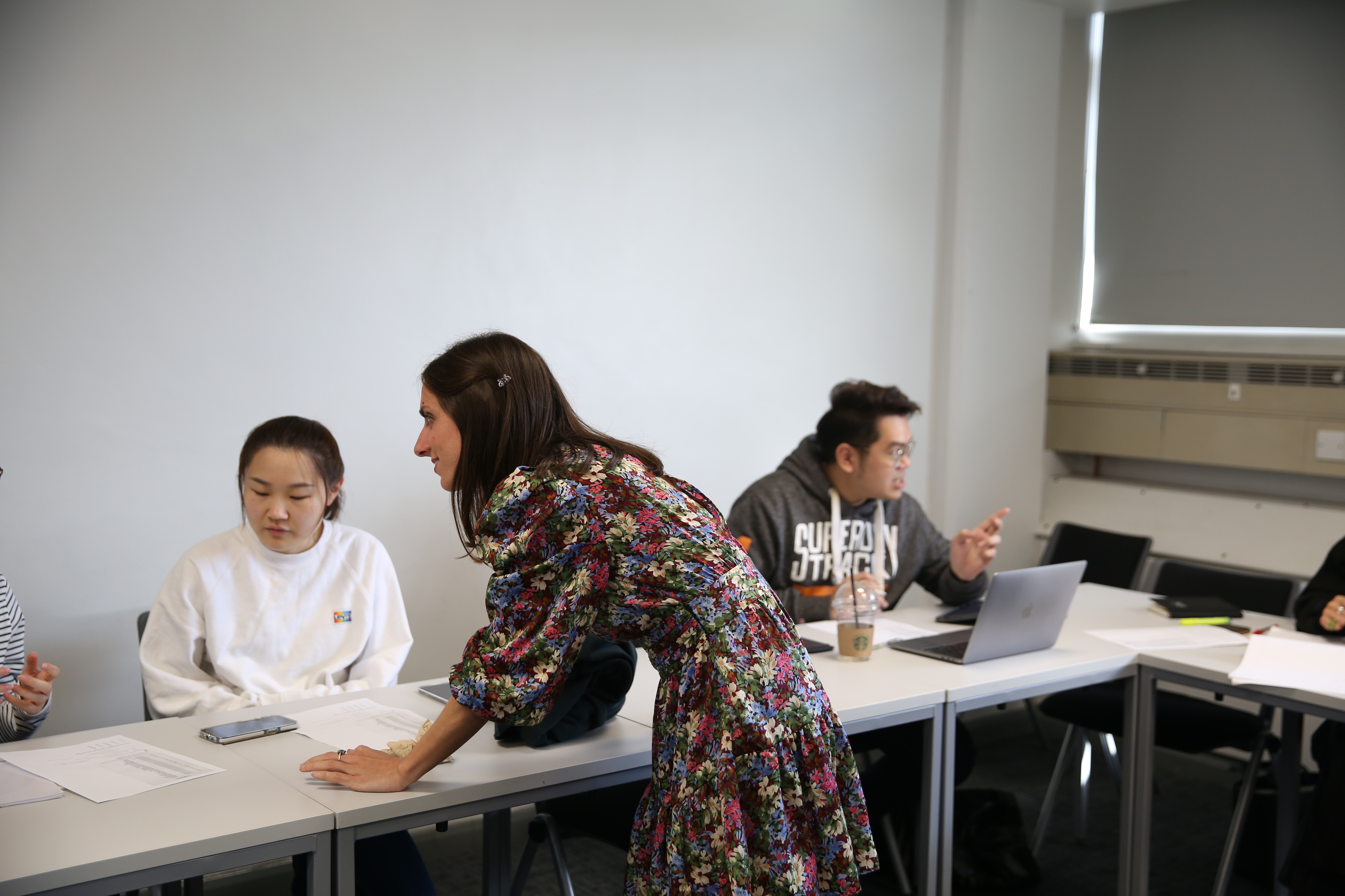 Lecturer in seminar giving support to a student