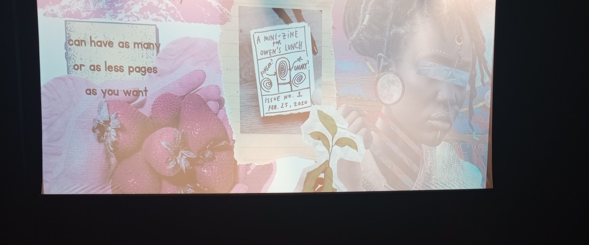 A photo of a projector screen showing a zine