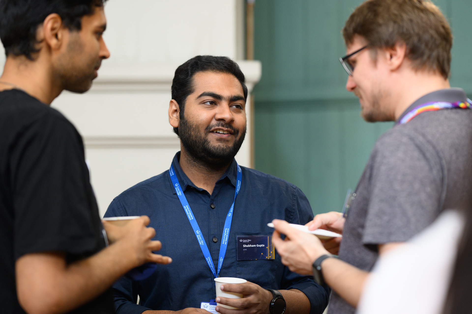 Three people talking to each other at a networking event