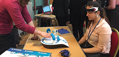 Girl wearing a headset used to control a game using brainwaves