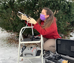 Elizabeth Clare crouching down to sample air